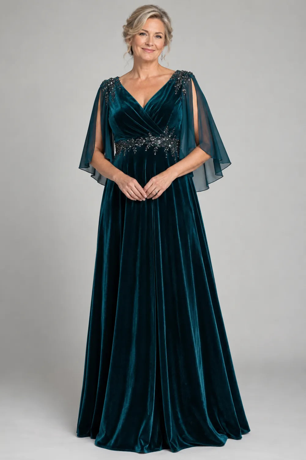 Teal dress with crossover bodice and decorated waist, front view.