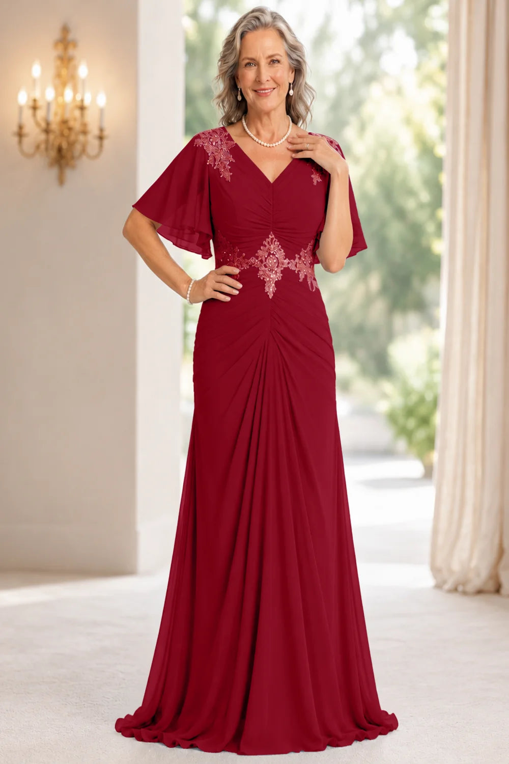 Front view of a wine red dress with flutter sleeves and a ruched front.