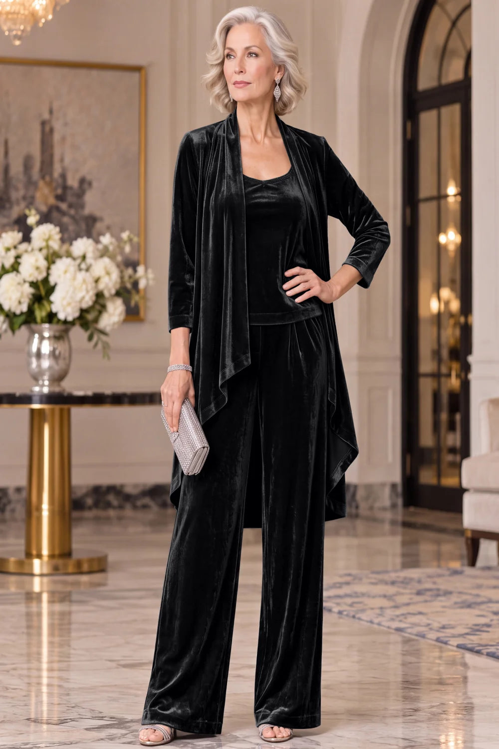 Front view of a black pant suit with a long waterfall jacket and wide-leg trousers.