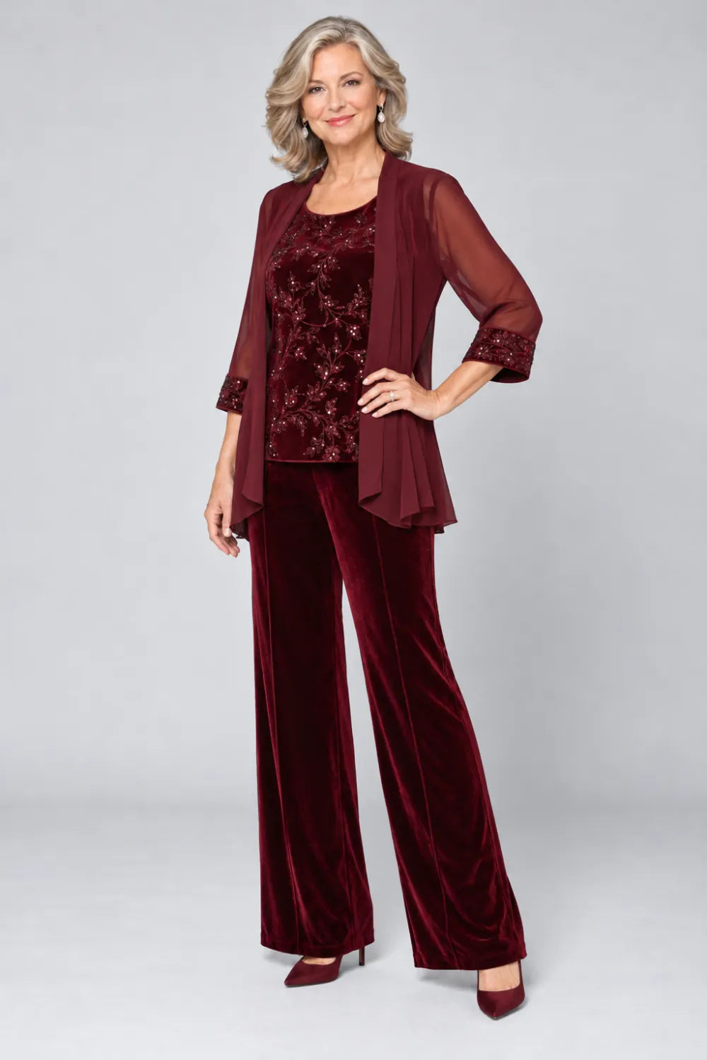 Burgundy pant suit with tonal floral top and matching cuff panels, front view.