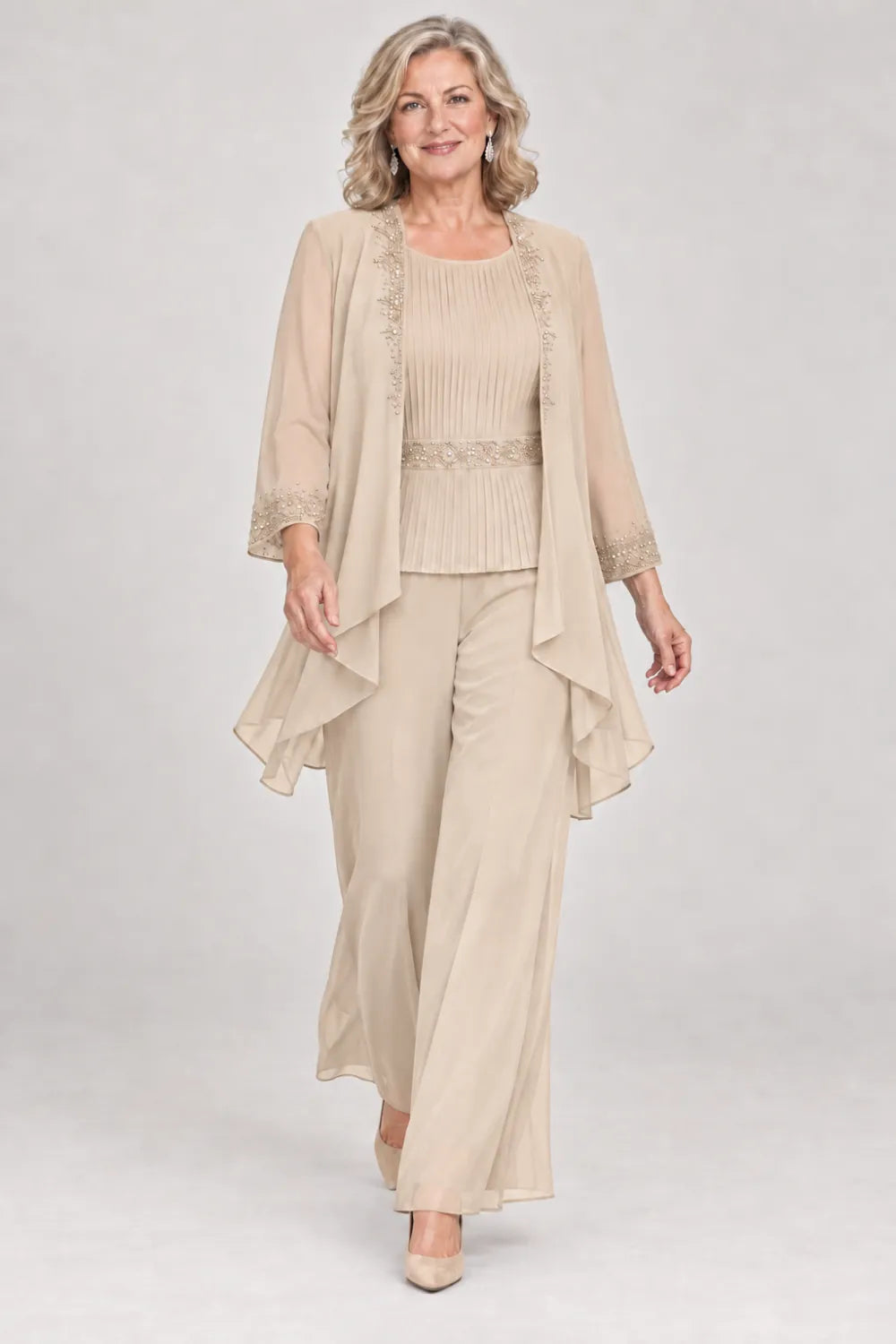 Champagne pant suit with pleated top and beaded waist, jacket edges and cuffs, front view.