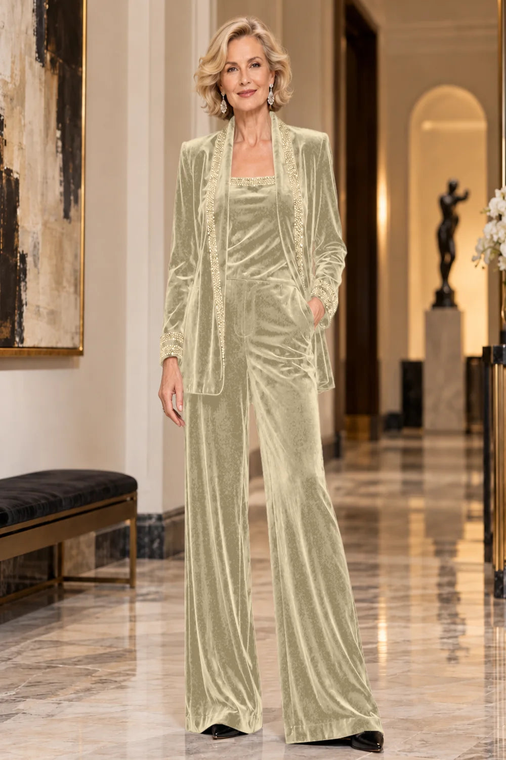 Front view of a champagne pant suit with a trimmed jacket, matching top and wide-leg trousers.