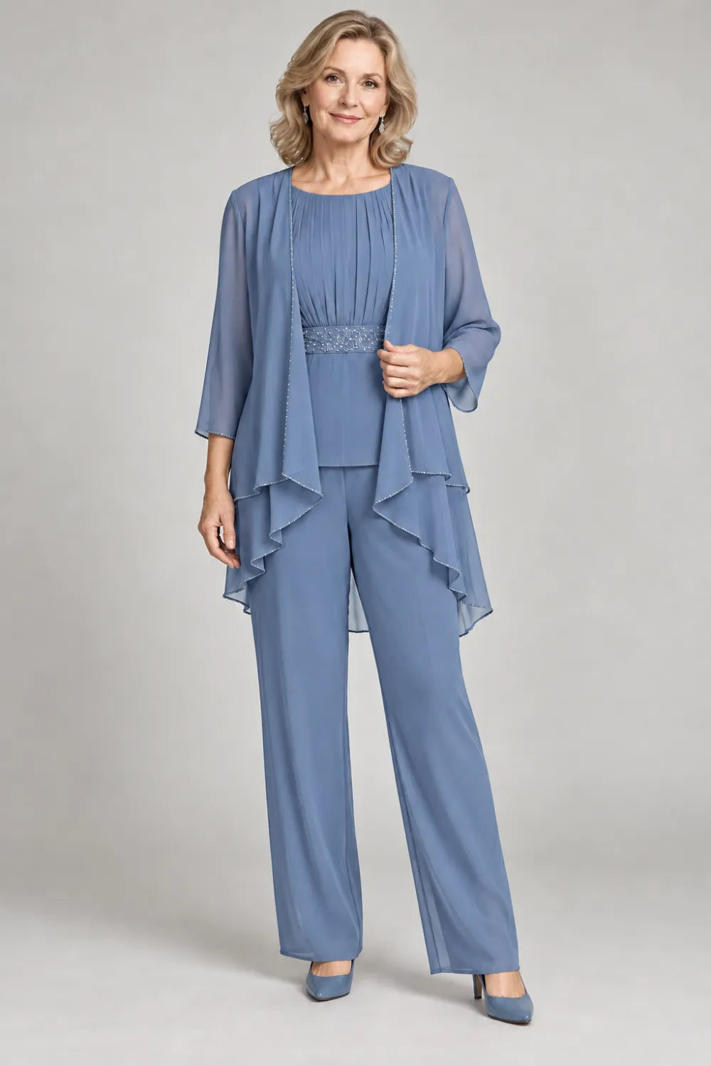 Dusty Blue pant suit with gathered top and decorated horizontal waist band, front view.