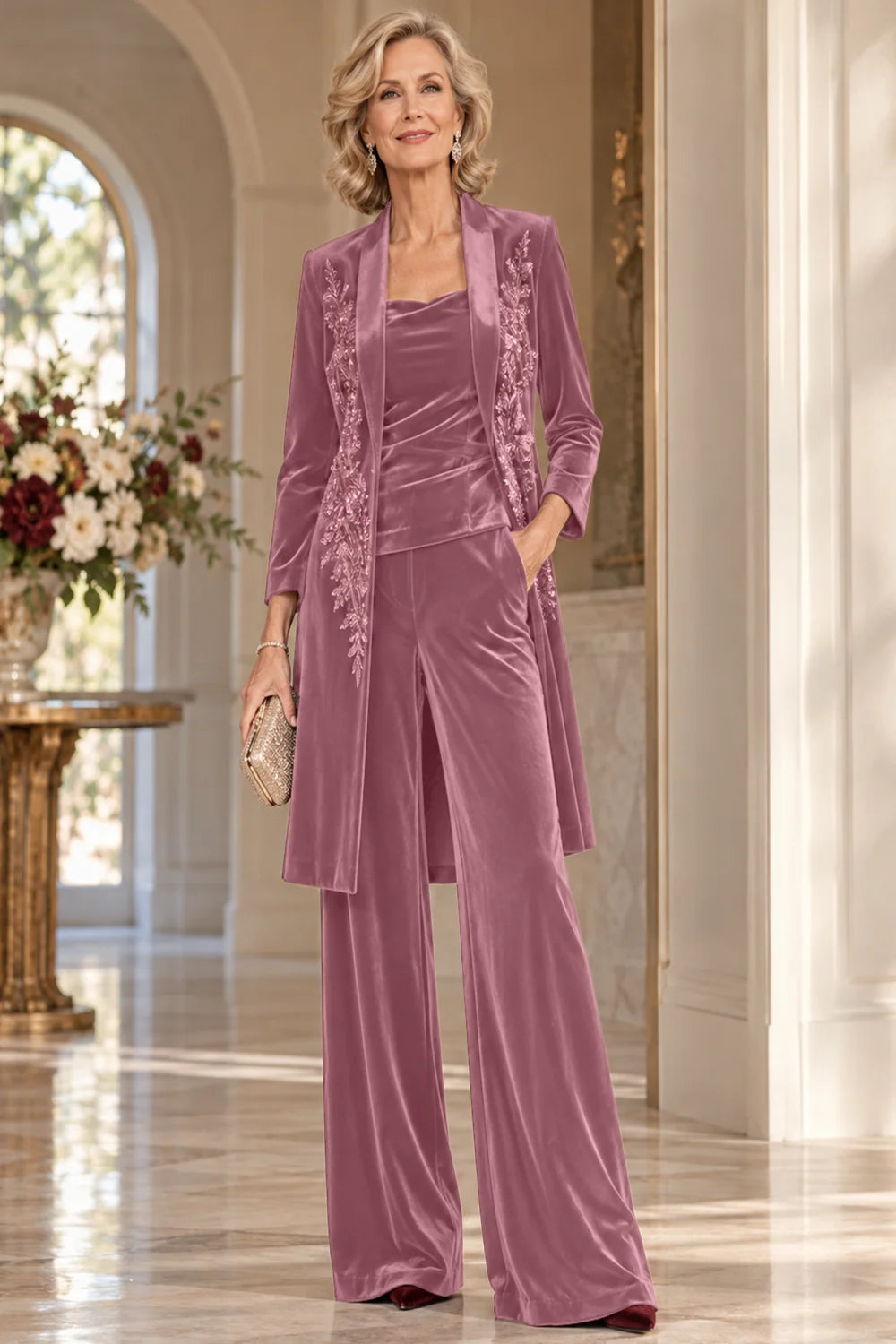 Front view of a dusty rose pant suit with a floral-trimmed long jacket and wide-leg trousers.