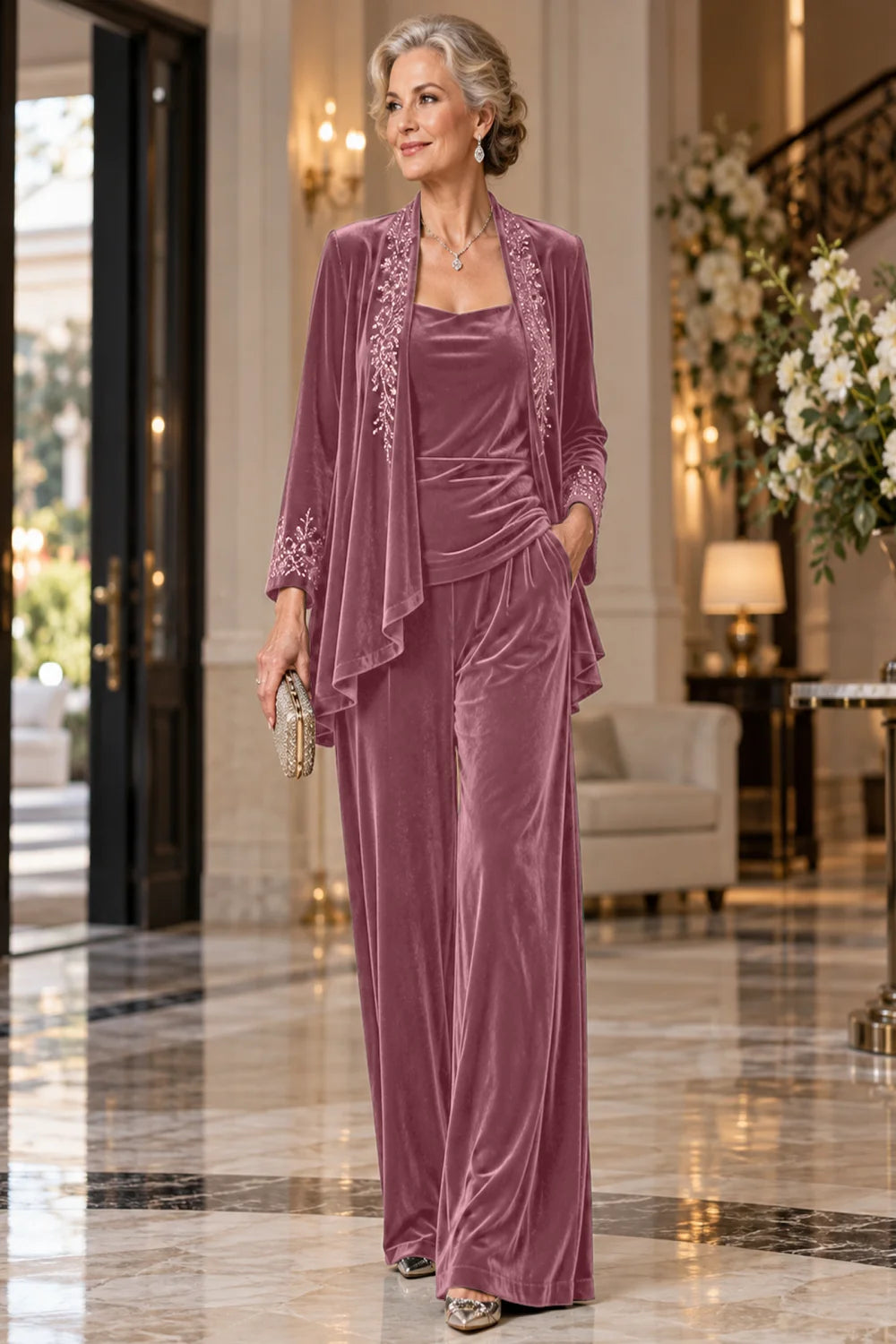 Front view of a dusty rose pant suit with an embellished jacket and matching trousers.