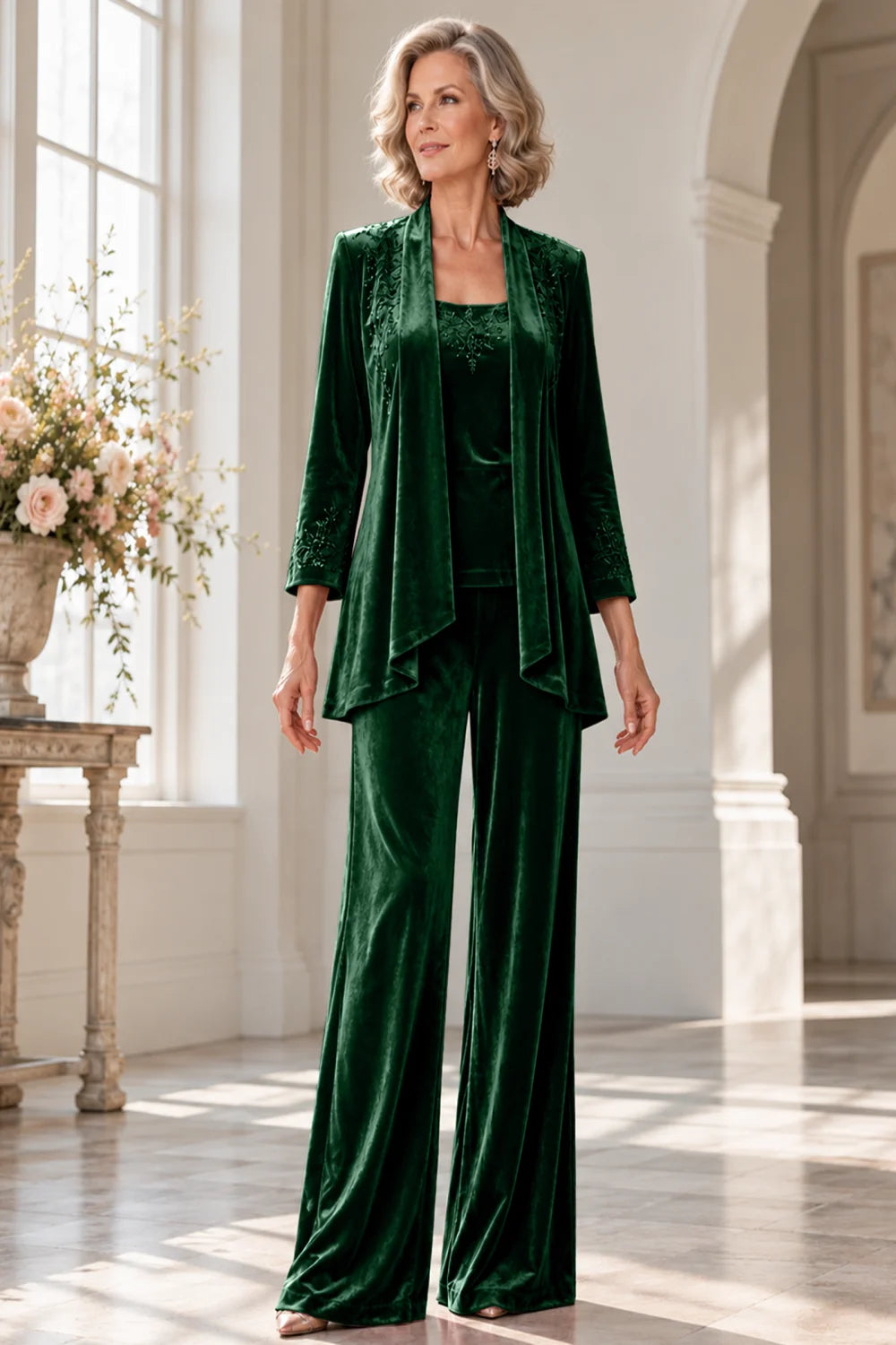 Front view of a emerald green pant suit with a waterfall jacket and matching trousers.