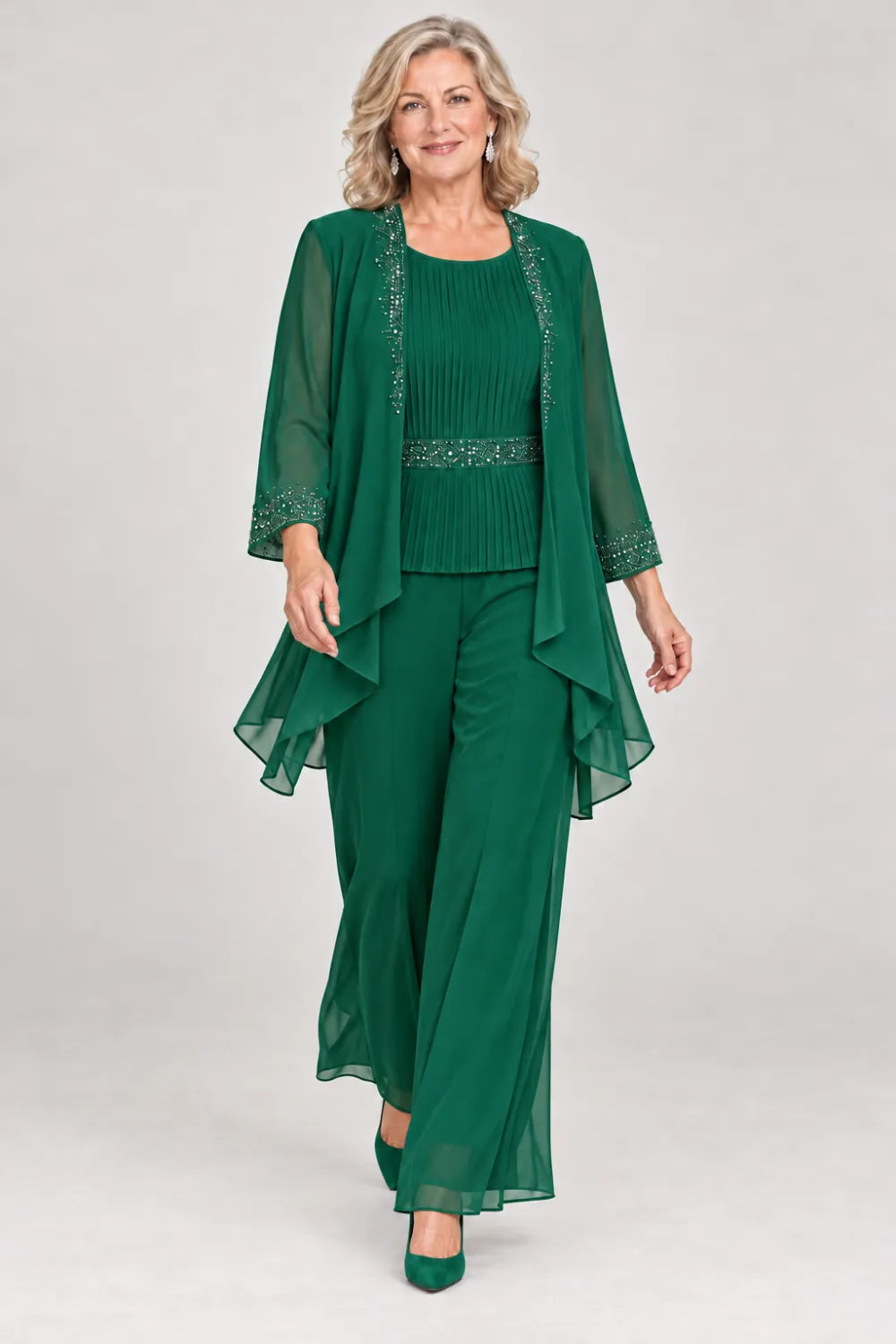 Emerald Green pant suit with pleated top and beaded waist, jacket edges and cuffs, front view.