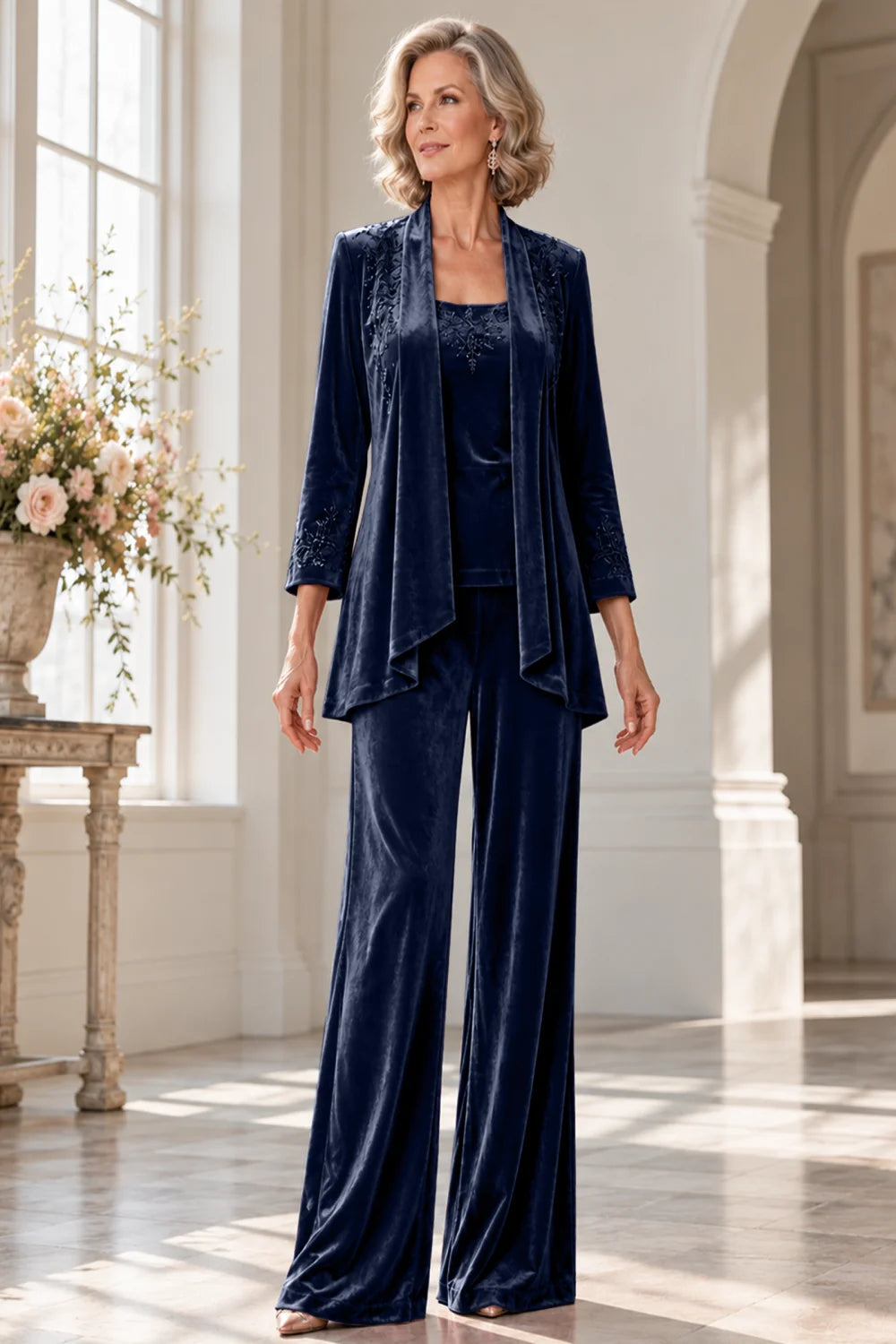 Front view of a navy blue pant suit with a waterfall jacket and matching trousers.