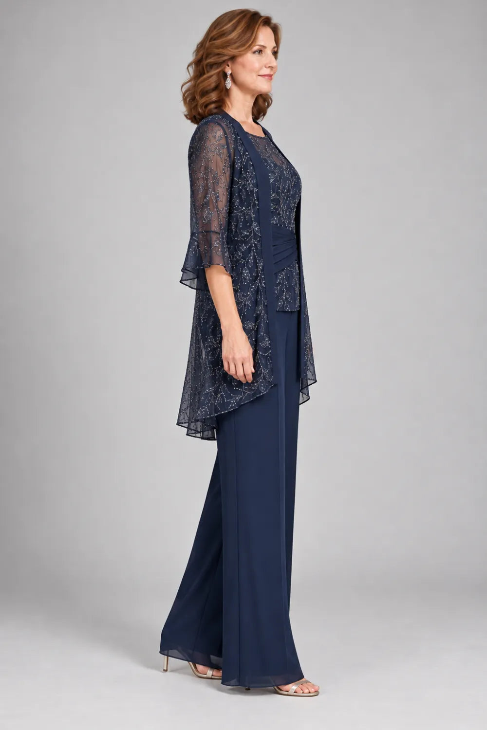 Navy Blue pant suit with floral lace top and diagonal gathered waist, side view.