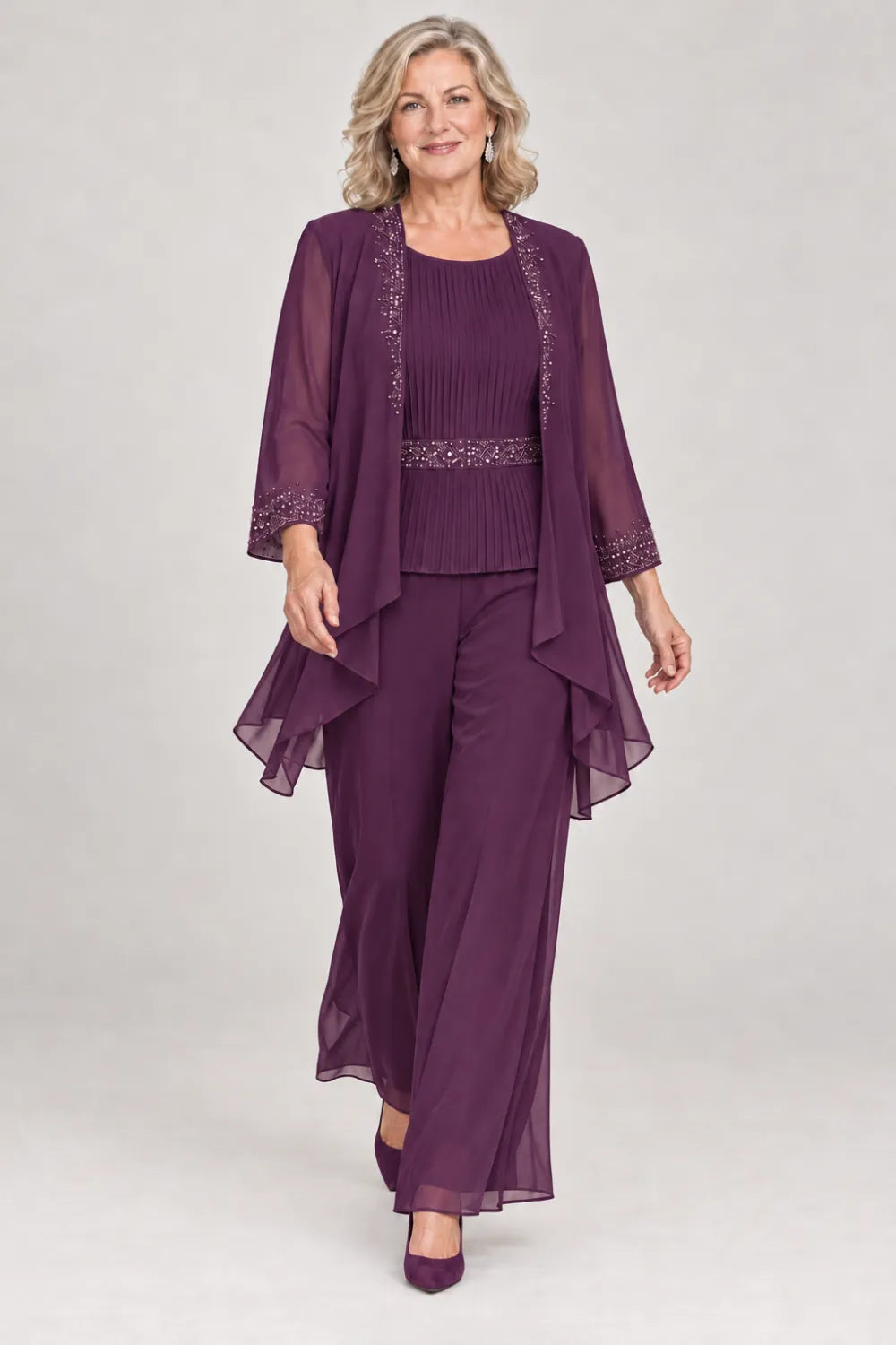 Plum pant suit with pleated top and beaded waist, jacket edges and cuffs, front view.