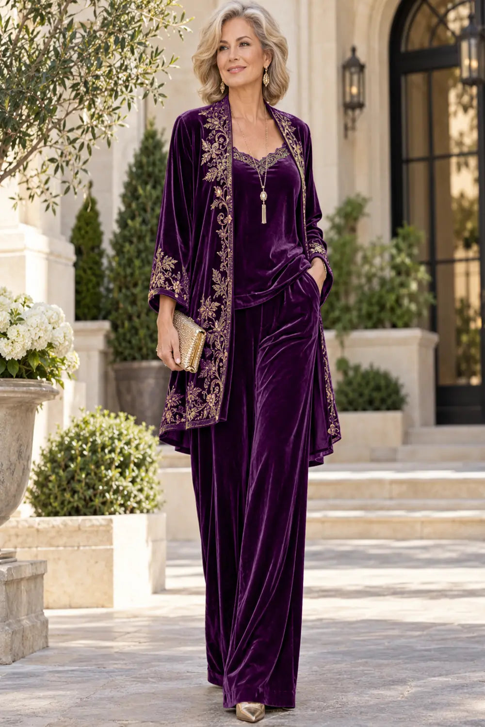 Front view of a purple pant suit with a floral-bordered long jacket and matching trousers.