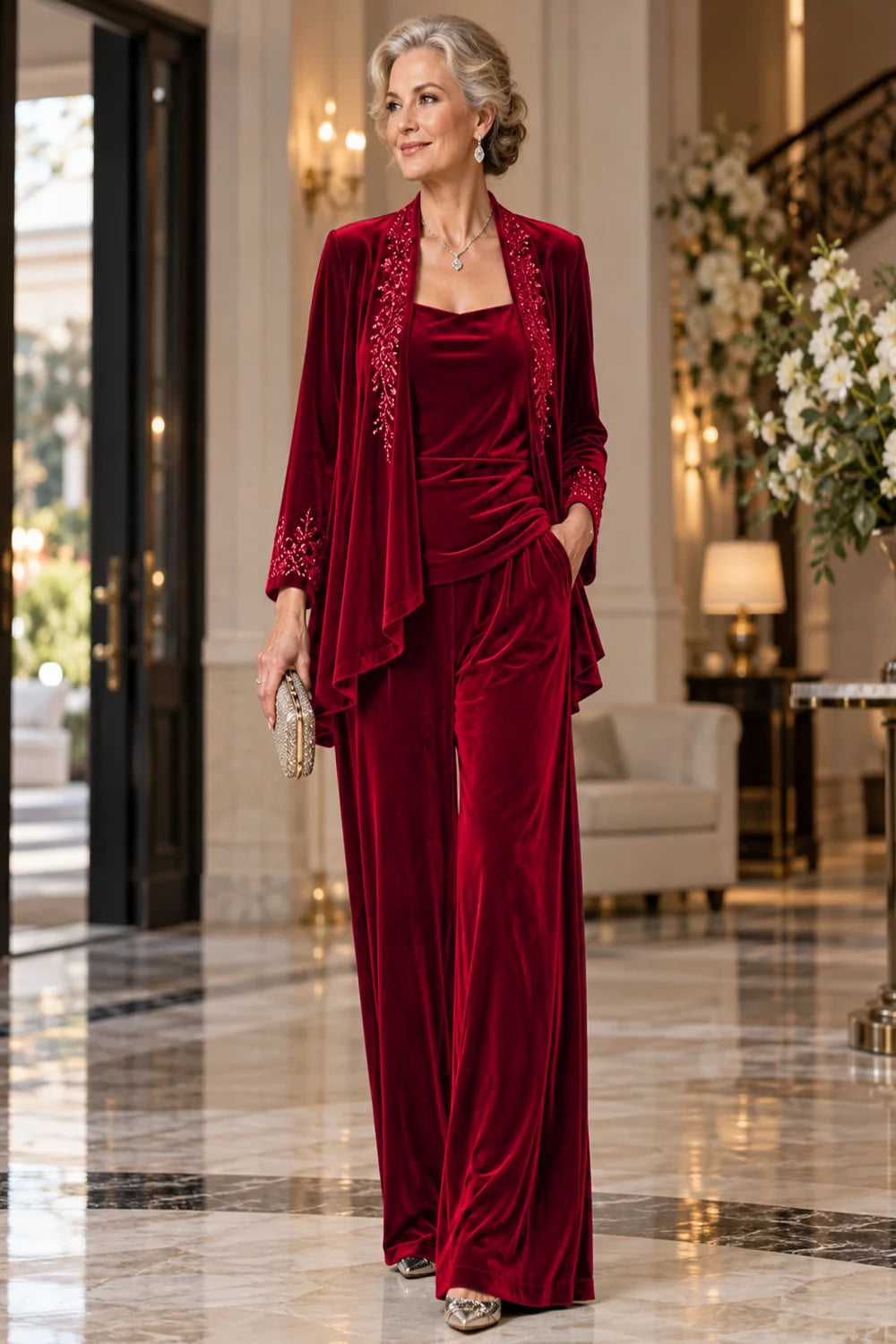 Front view of a red pant suit with an embellished jacket and matching trousers.