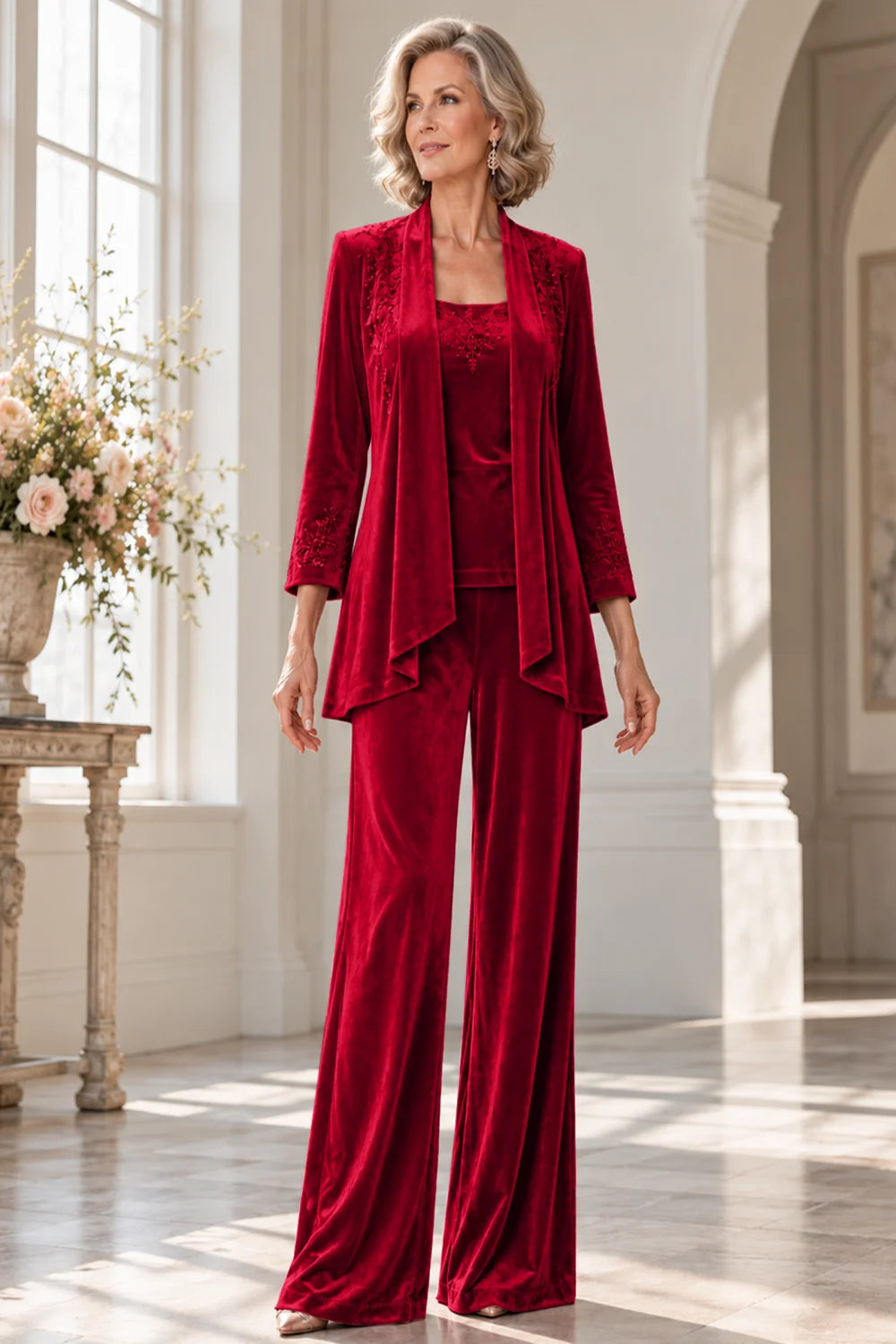 Front view of a red pant suit with a waterfall jacket and matching trousers.