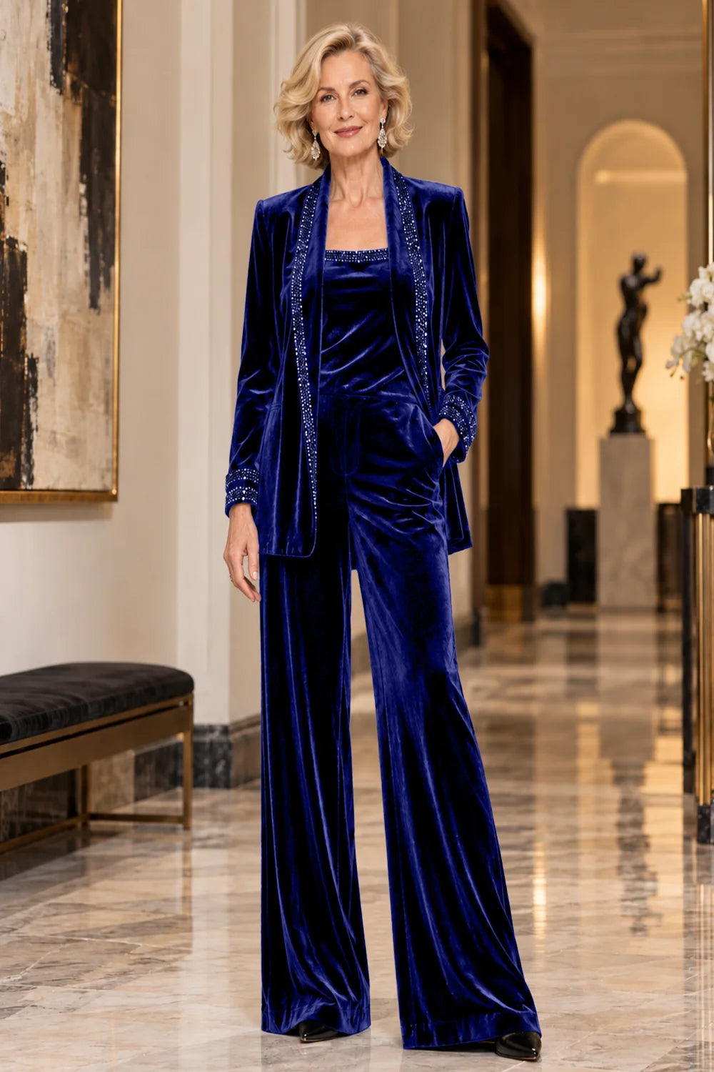 Front view of a royal blue pant suit with a trimmed jacket, matching top and wide-leg trousers.