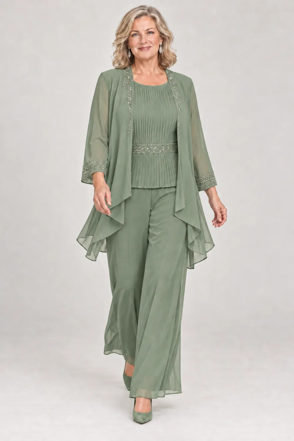Sage Green pant suit with pleated top and beaded waist, jacket edges and cuffs, front view.