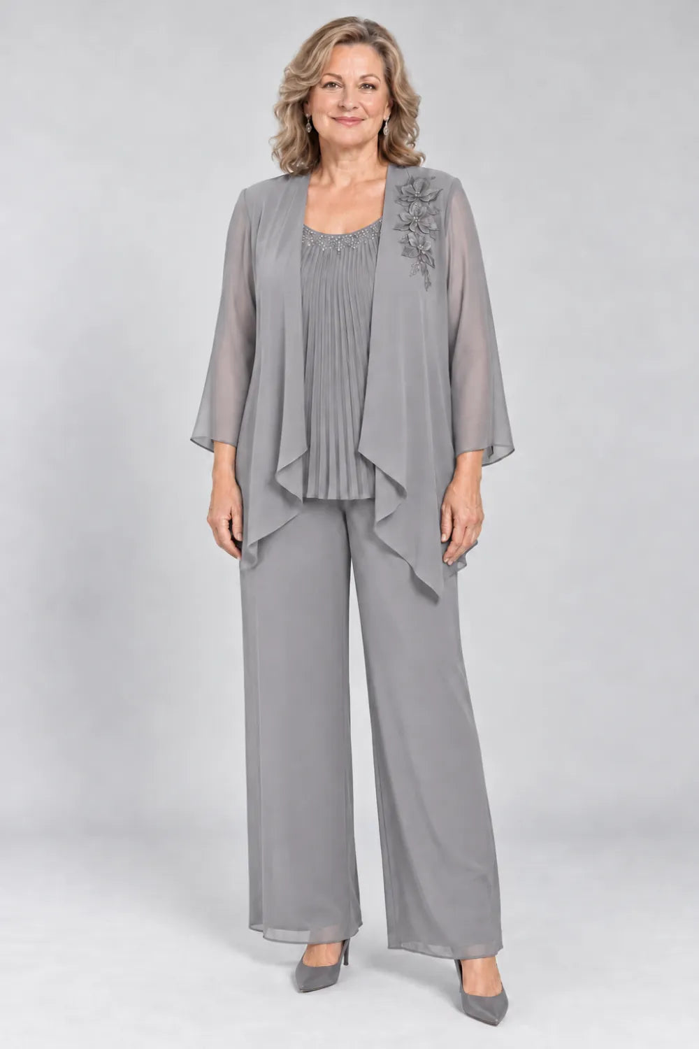 Silver Gray pant suit with fine pleats, decorated neckline and floral shoulder motif, front view.