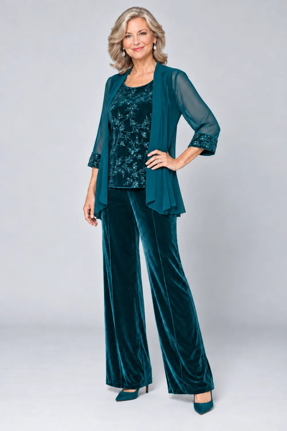 Teal pant suit with tonal floral top and matching cuff panels, front view.