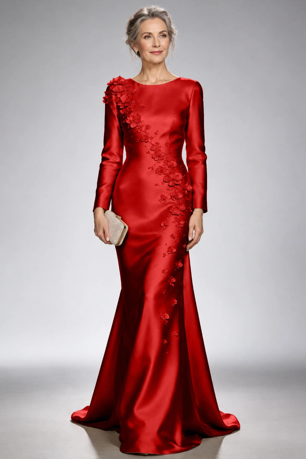 Front view of the red satin mermaid dress with long sleeves and diagonal floral appliques across the bodice and skirt.